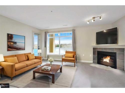 306-4425 Heritage Way, Lacombe, AB - Indoor Photo Showing Living Room With Fireplace