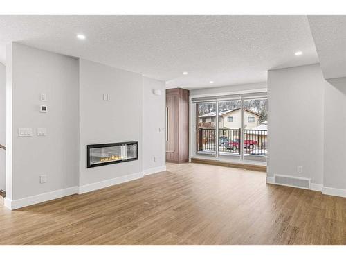 Unit 3-1615 1 Avenue, Canmore, AB - Indoor Photo Showing Living Room With Fireplace