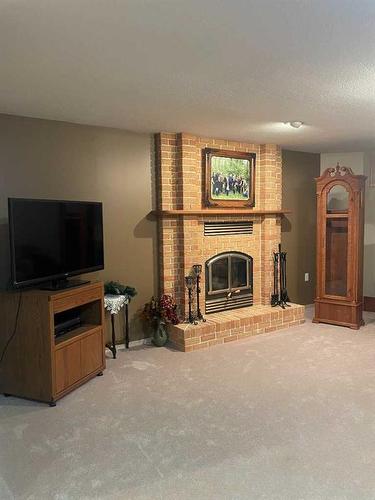 5208 51 Avenue, Consort, AB - Indoor Photo Showing Living Room With Fireplace