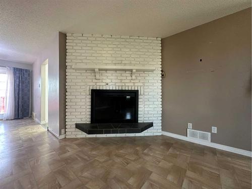 5421 51 Street, Camrose, AB - Indoor Photo Showing Living Room With Fireplace