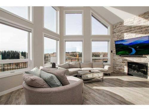 110-25173 Township Road 364, Rural Red Deer County, AB - Indoor Photo Showing Living Room With Fireplace