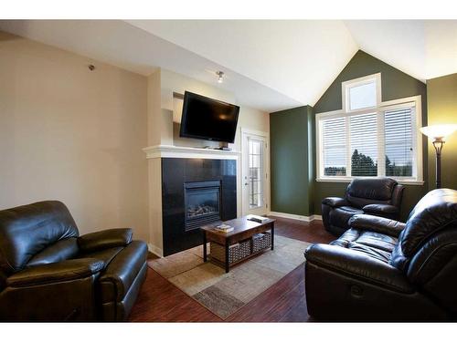 407-4707 50 Street, Sylvan Lake, AB - Indoor Photo Showing Living Room With Fireplace