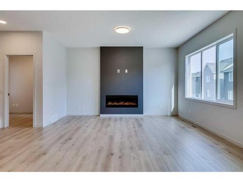 1466 Bayview Point Sw, Airdrie, AB - Indoor Photo Showing Living Room With Fireplace