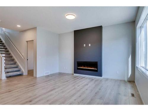 1466 Bayview Point Sw, Airdrie, AB - Indoor Photo Showing Living Room With Fireplace