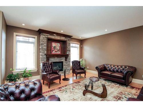 64 Cyprus Road, Blackfalds, AB - Indoor Photo Showing Living Room With Fireplace