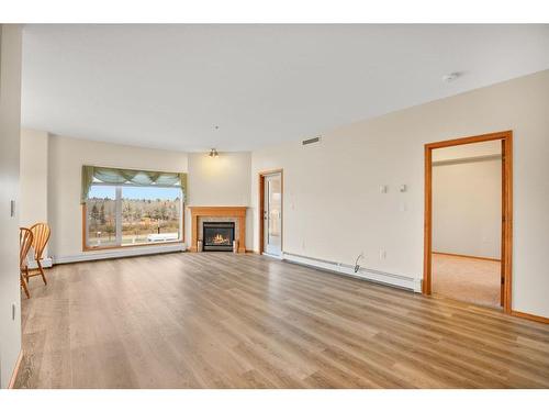 205-5590 45 Street, Red Deer, AB - Indoor Photo Showing Living Room With Fireplace