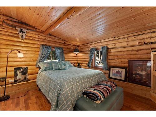 6E West Ghost Road, Benchlands, AB - Indoor Photo Showing Bedroom With Fireplace