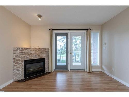 606-5220 50A Avenue, Sylvan Lake, AB - Indoor Photo Showing Living Room With Fireplace