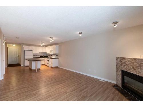 606-5220 50A Avenue, Sylvan Lake, AB - Indoor Photo Showing Living Room With Fireplace