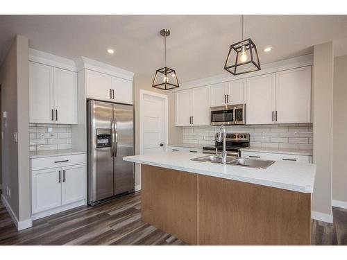 122 Mann Drive, Penhold, AB - Indoor Photo Showing Kitchen With Stainless Steel Kitchen With Double Sink With Upgraded Kitchen