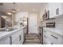 122 Mann Drive, Penhold, AB  - Indoor Photo Showing Kitchen With Stainless Steel Kitchen With Double Sink With Upgraded Kitchen 