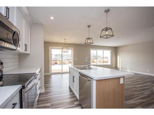 122 Mann Drive, Penhold, AB - Indoor Photo Showing Kitchen With Double Sink With Upgraded Kitchen