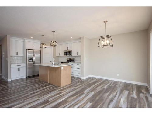 122 Mann Drive, Penhold, AB - Indoor Photo Showing Kitchen With Stainless Steel Kitchen With Upgraded Kitchen