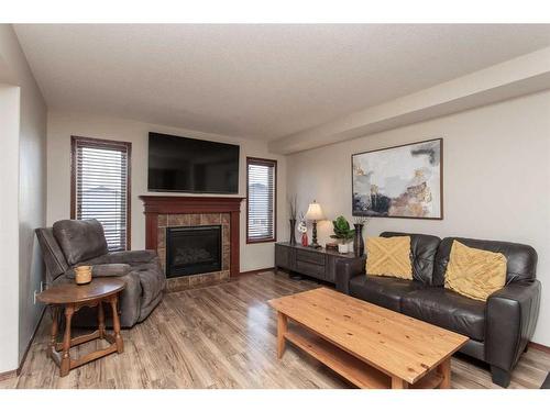 56 Lodge Place, Sylvan Lake, AB - Indoor Photo Showing Living Room With Fireplace