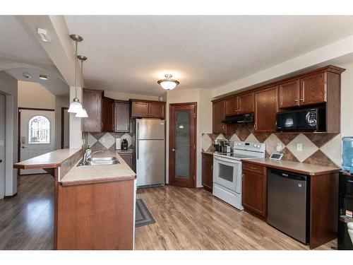 56 Lodge Place, Sylvan Lake, AB - Indoor Photo Showing Kitchen With Double Sink