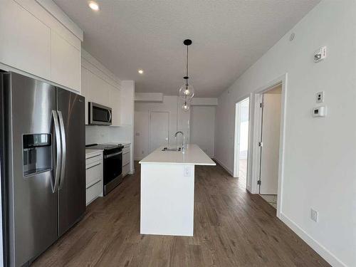 4408-111 Wolf Creek Drive, Calgary, AB - Indoor Photo Showing Kitchen With Stainless Steel Kitchen