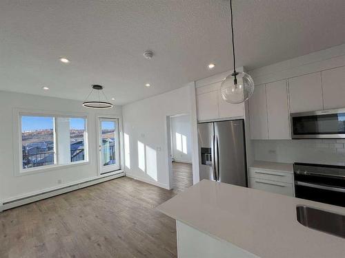 4408-111 Wolf Creek Drive, Calgary, AB - Indoor Photo Showing Kitchen With Stainless Steel Kitchen With Upgraded Kitchen