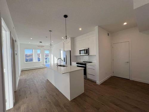 4408-111 Wolf Creek Drive, Calgary, AB - Indoor Photo Showing Kitchen With Stainless Steel Kitchen With Double Sink With Upgraded Kitchen