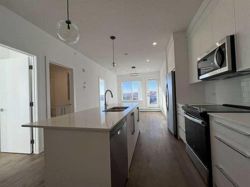 4408-111 Wolf Creek Drive, Calgary, AB - Indoor Photo Showing Kitchen With Double Sink With Upgraded Kitchen