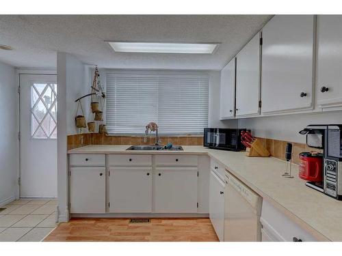 77 Baile Close North, Red Deer, AB - Indoor Photo Showing Kitchen With Double Sink