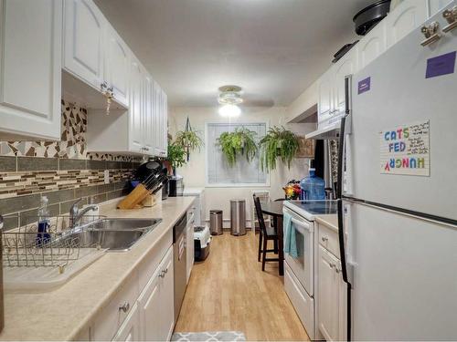 102-4904 54 Street West, Red Deer, AB - Indoor Photo Showing Kitchen With Double Sink