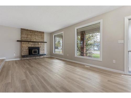 112 Sanden Street, Bawlf, AB - Indoor Photo Showing Living Room With Fireplace