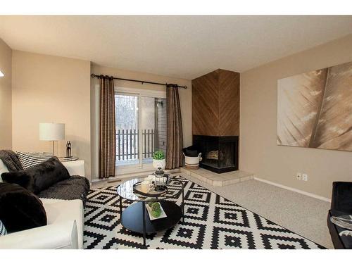 7-80 Piper Drive, Red Deer, AB - Indoor Photo Showing Living Room With Fireplace