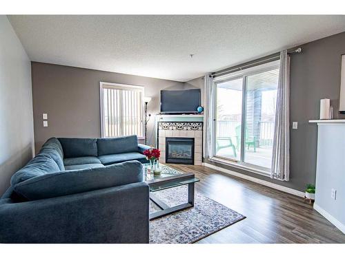 101-60 Lawford Avenue, Red Deer, AB - Indoor Photo Showing Living Room With Fireplace