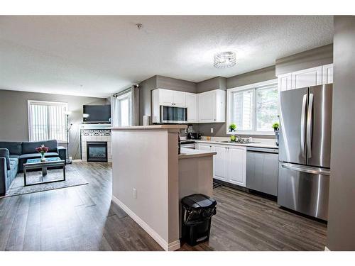 101-60 Lawford Avenue, Red Deer, AB - Indoor Photo Showing Kitchen With Fireplace