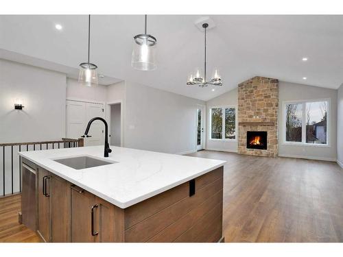 101-5300 60 Street, Sylvan Lake, AB - Indoor Photo Showing Kitchen With Fireplace