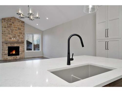 101-5300 60 Street, Sylvan Lake, AB - Indoor Photo Showing Kitchen With Fireplace With Double Sink