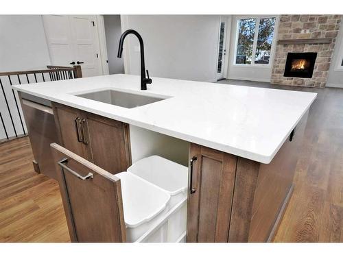 101-5300 60 Street, Sylvan Lake, AB - Indoor Photo Showing Kitchen With Fireplace