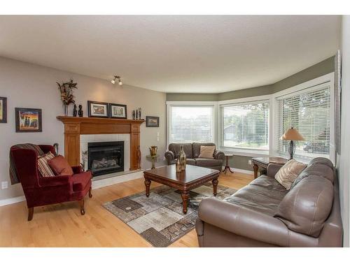 14 Pickwick Lane, Lacombe, AB - Indoor Photo Showing Living Room With Fireplace