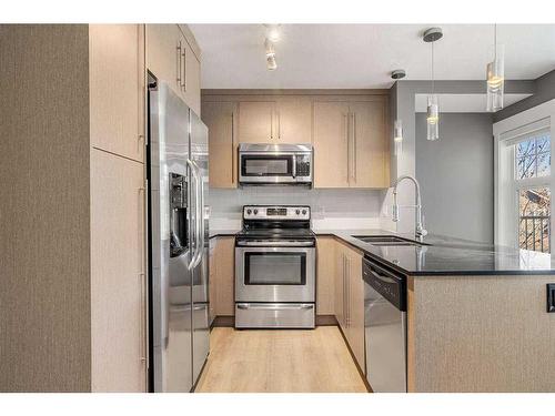 1210-11 Mahogany Row Se, Calgary, AB - Indoor Photo Showing Kitchen With Stainless Steel Kitchen With Double Sink With Upgraded Kitchen