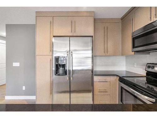 1210-11 Mahogany Row Se, Calgary, AB - Indoor Photo Showing Kitchen With Stainless Steel Kitchen