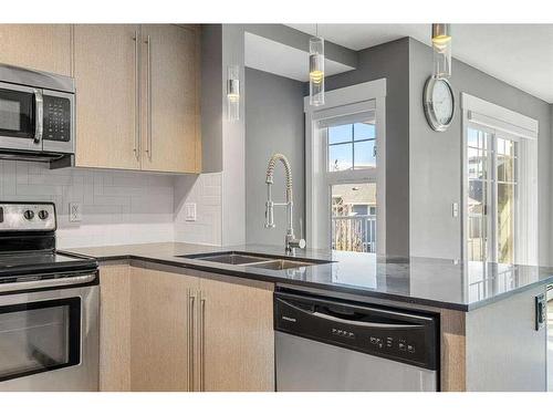 1210-11 Mahogany Row Se, Calgary, AB - Indoor Photo Showing Kitchen With Stainless Steel Kitchen With Double Sink