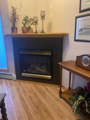 305-5300 48 Street, Red Deer, AB - Indoor Photo Showing Living Room With Fireplace