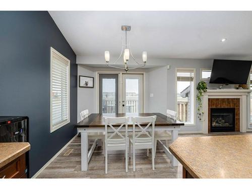 70 Rozier Close, Sylvan Lake, AB - Indoor Photo Showing Dining Room With Fireplace