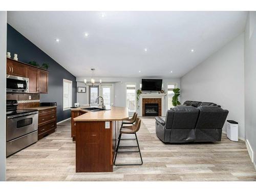 70 Rozier Close, Sylvan Lake, AB - Indoor Photo Showing Kitchen With Fireplace