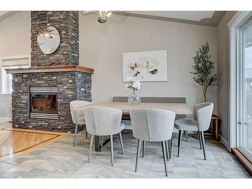 34 Fieldstone Way, Sylvan Lake, AB - Indoor Photo Showing Dining Room With Fireplace