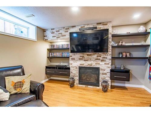 16 Mckinlay Crescent, Lacombe, AB - Indoor Photo Showing Living Room With Fireplace