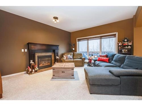 67 Burris Pointe, Lacombe, AB - Indoor Photo Showing Living Room With Fireplace