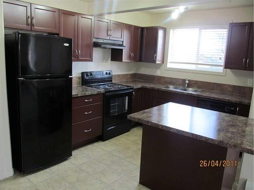 307-5601 Kerrywood Drive, Red Deer, AB - Indoor Photo Showing Kitchen With Double Sink