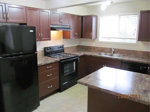 307-5601 Kerrywood Drive, Red Deer, AB - Indoor Photo Showing Kitchen With Double Sink