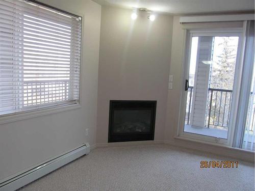 307-5601 Kerrywood Drive, Red Deer, AB - Indoor Photo Showing Other Room With Fireplace