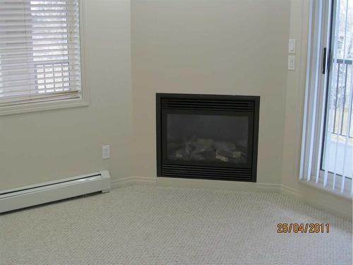 307-5601 Kerrywood Drive, Red Deer, AB - Indoor Photo Showing Living Room With Fireplace