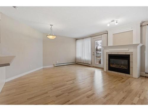 208-5419 49 Avenue, Camrose, AB - Indoor Photo Showing Living Room With Fireplace