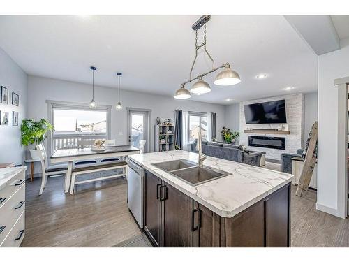 73 Chinook Street, Blackfalds, AB - Indoor Photo Showing Kitchen With Fireplace With Double Sink With Upgraded Kitchen