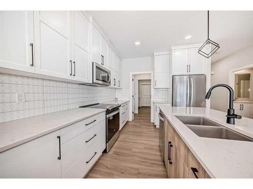 15 Rosse Place, Sylvan Lake, AB - Indoor Photo Showing Kitchen With Stainless Steel Kitchen With Double Sink With Upgraded Kitchen