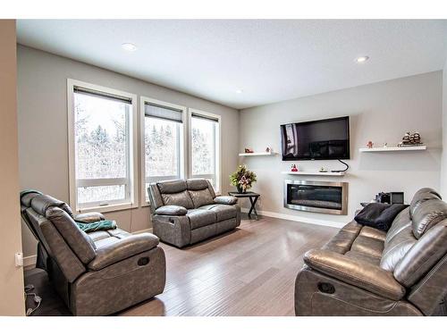 119 Cedar Square, Blackfalds, AB - Indoor Photo Showing Living Room With Fireplace